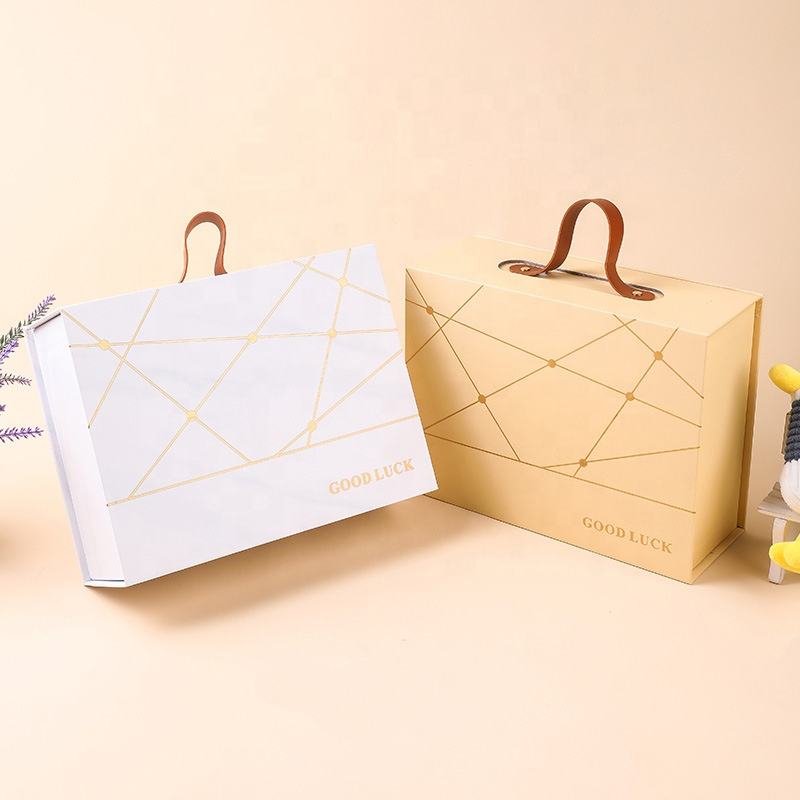 Custom Gold Geometric Line Magnetic Book-Style Gift Box with Leather Handle | Cream White Gold Forest Green Gold Foil Grid & Good Luck Stamp Brown PU Leather Handle for Beauty Tea Health Holiday Gift Set | MOQ 100 pcs