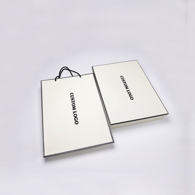 Caja de regalo personalizada de dos piezas con tapa y base color marfil y bolsa a juego | Logotipo impreso con borde negro y cinta de marca para ropa, bufandas y embalaje de marcas de lujo | Cantidad mínima de pedido: 100 unidades