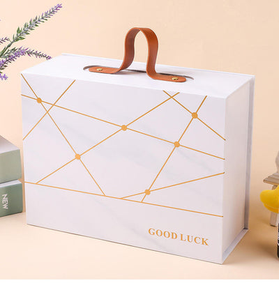 Custom Gold Geometric Line Magnetic Book-Style Gift Box with Leather Handle | Cream White Gold Forest Green Gold Foil Grid & Good Luck Stamp Brown PU Leather Handle for Beauty Tea Health Holiday Gift Set | MOQ 100 pcs